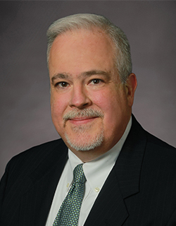 person with white hair wearing a suit