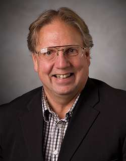 man wearing suit and glasses