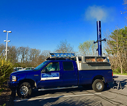 blue pickup truck with white smoke stack