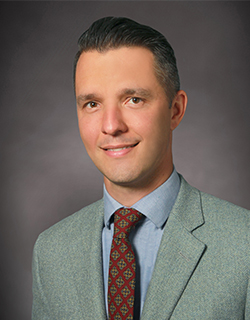 headshot of male wearing a suit